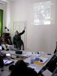 Photo of Claire Scott giving her talk in traditional Civil War re-enactment clothing and attendees listening to her talk.