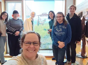 selfie of group in front of dude ranches exhibition banner